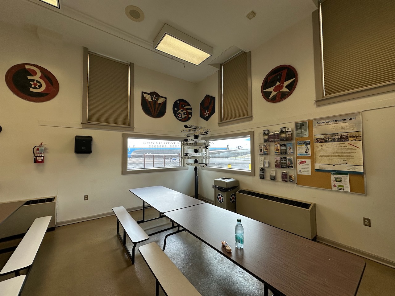 Canteen, with cafeteria tables in room and numerous museum artifacts on walls.
