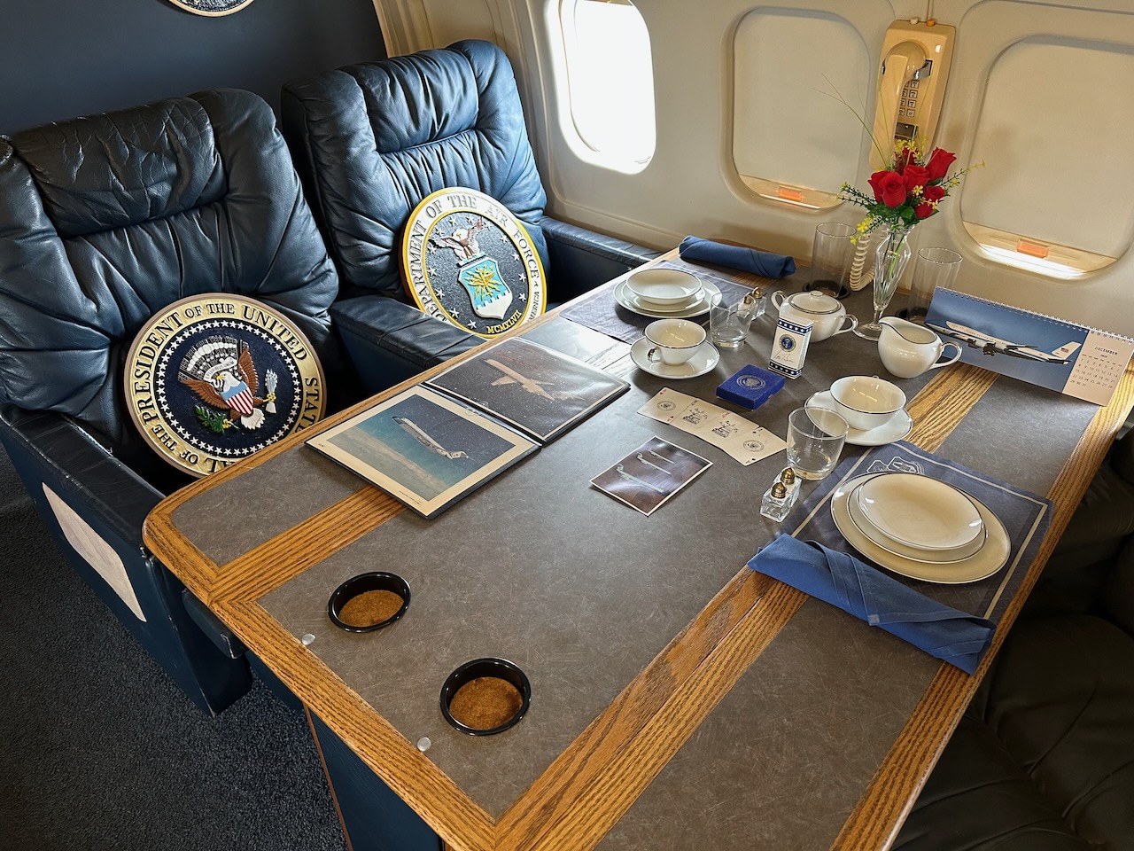 Conference table with chairs. The table holds different memorabilia from the various Vice Presidents who flew on board.