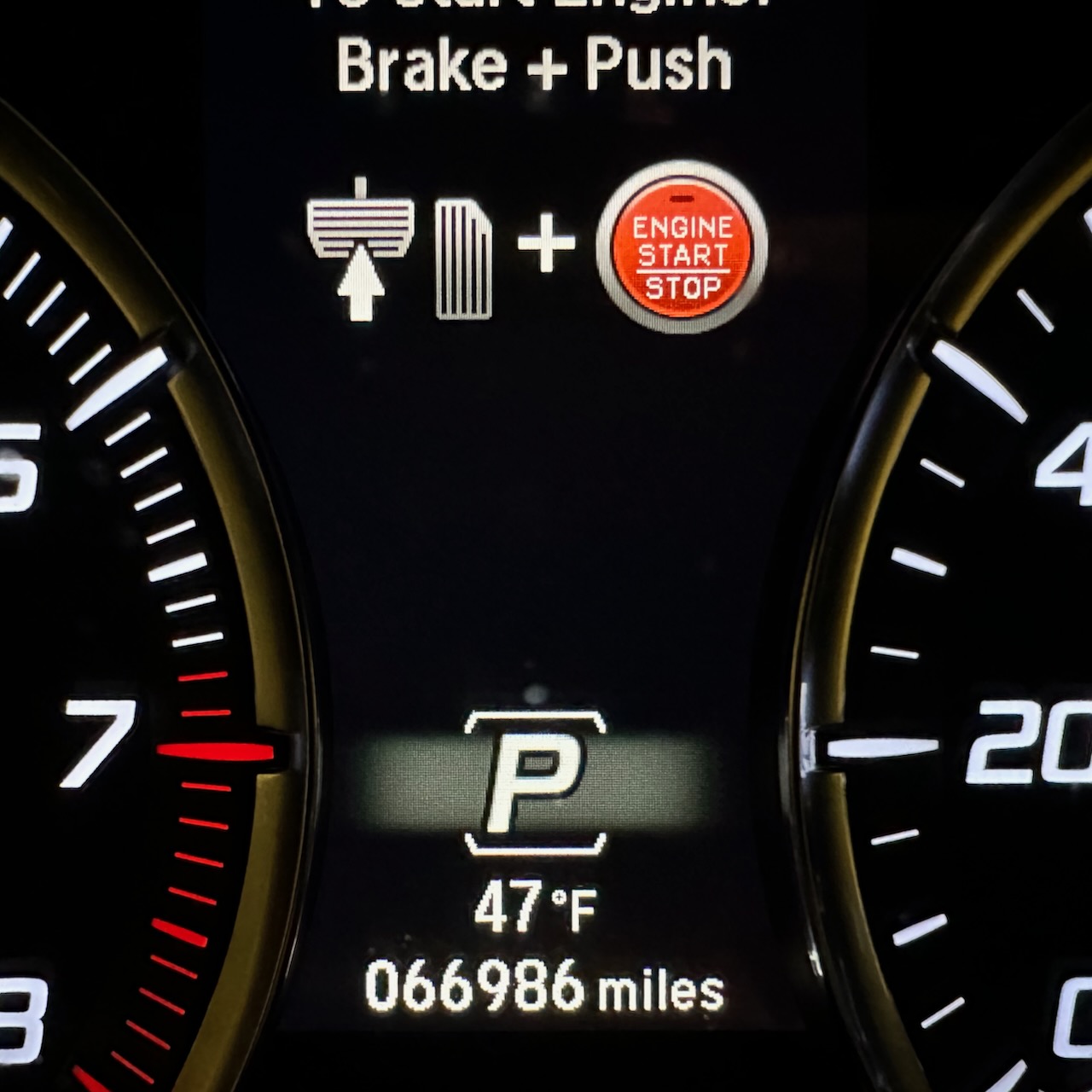 Car odometer reading 66986 miles.