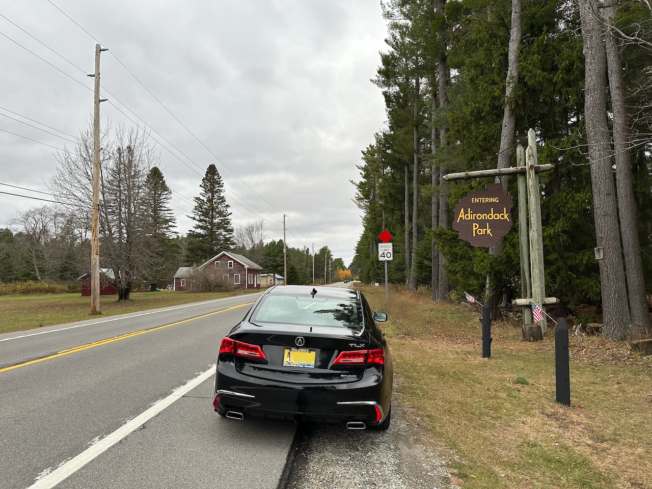 2020 Acura TLX parked on side of road beside sign that says ENTERING ADIRONDACK PARK