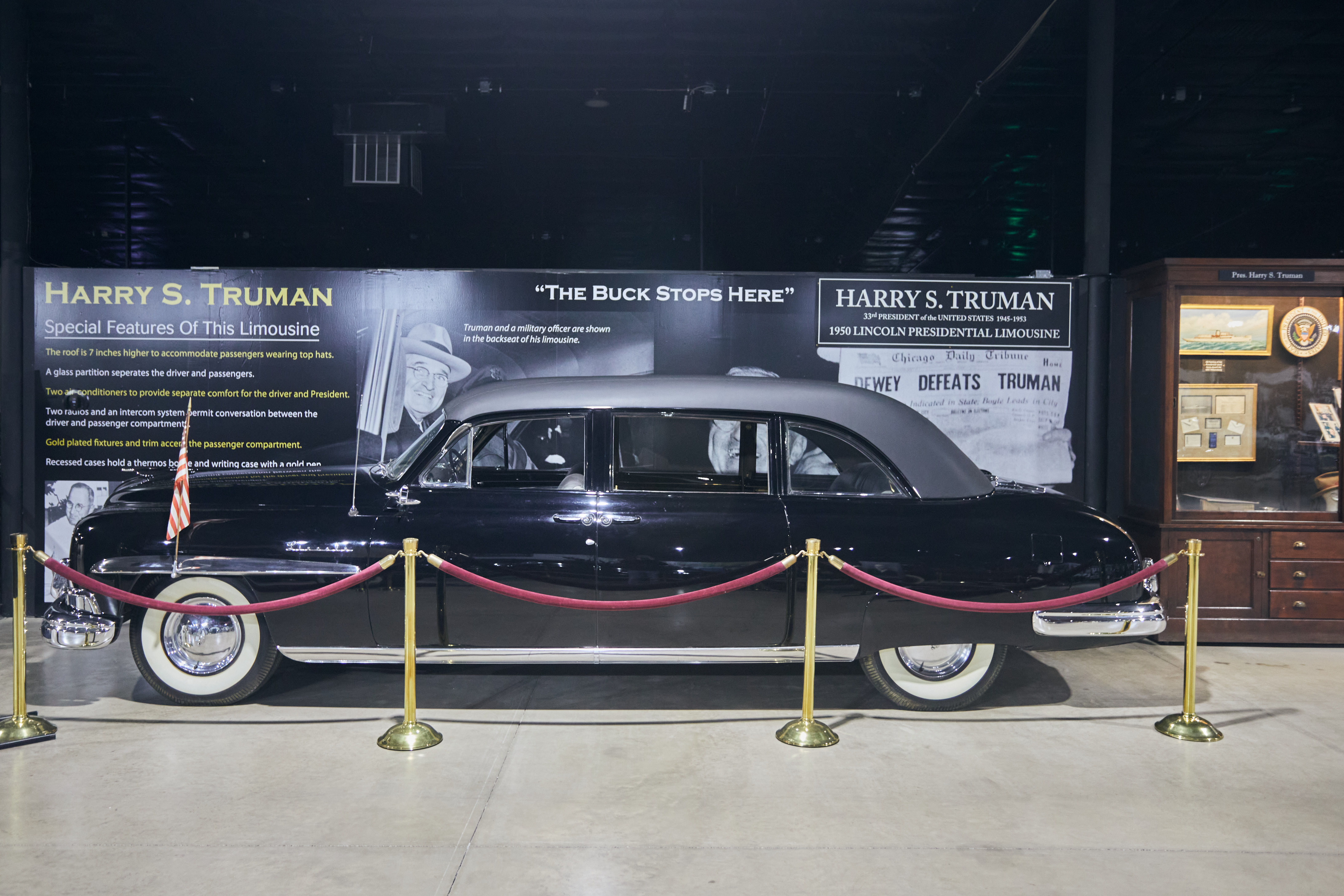 1950 Lincoln sedan with display of Harry Truman in background.