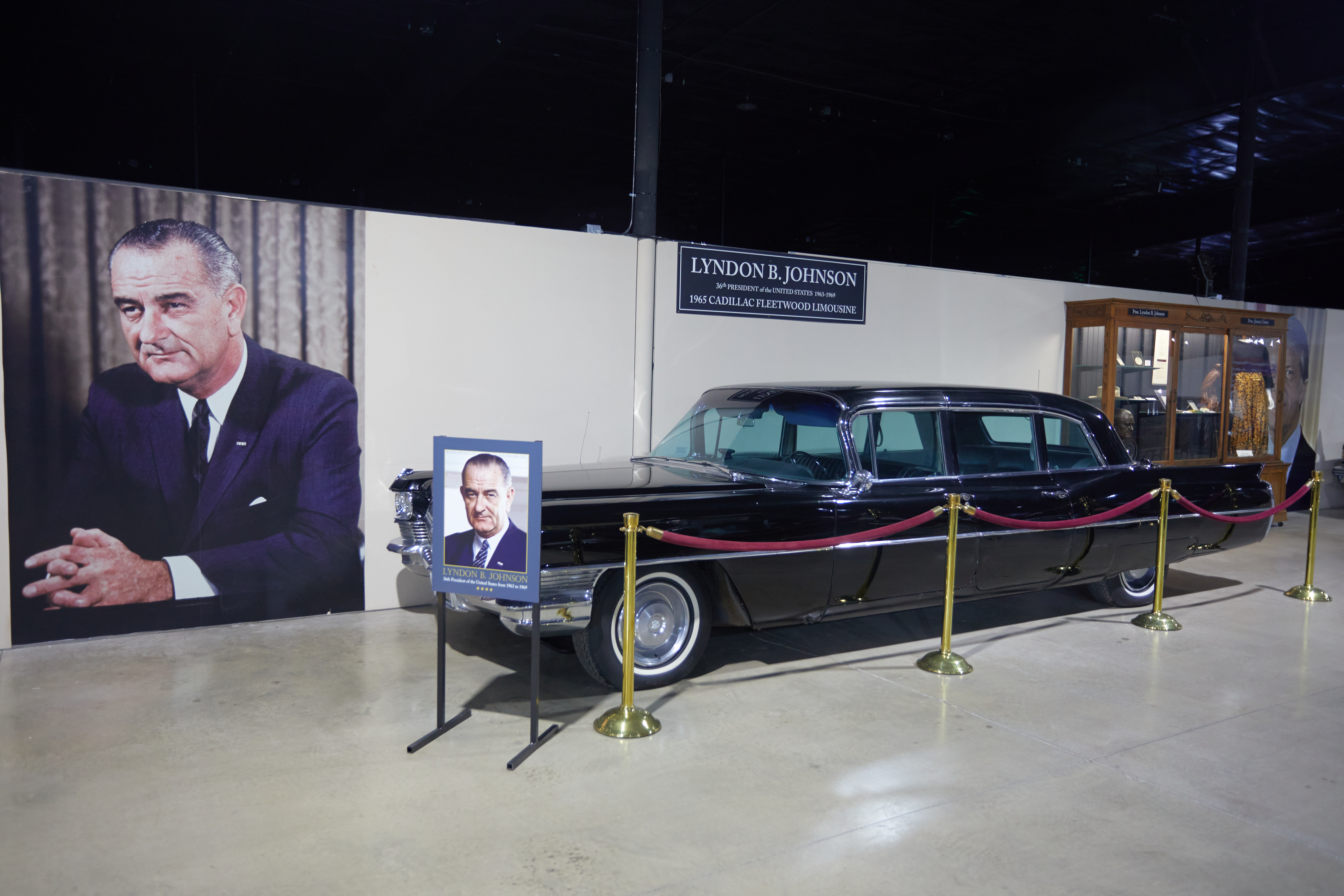 1965 Cadillac Fleetwood limousine with picture of President Lyndon Baines Johnson in background.