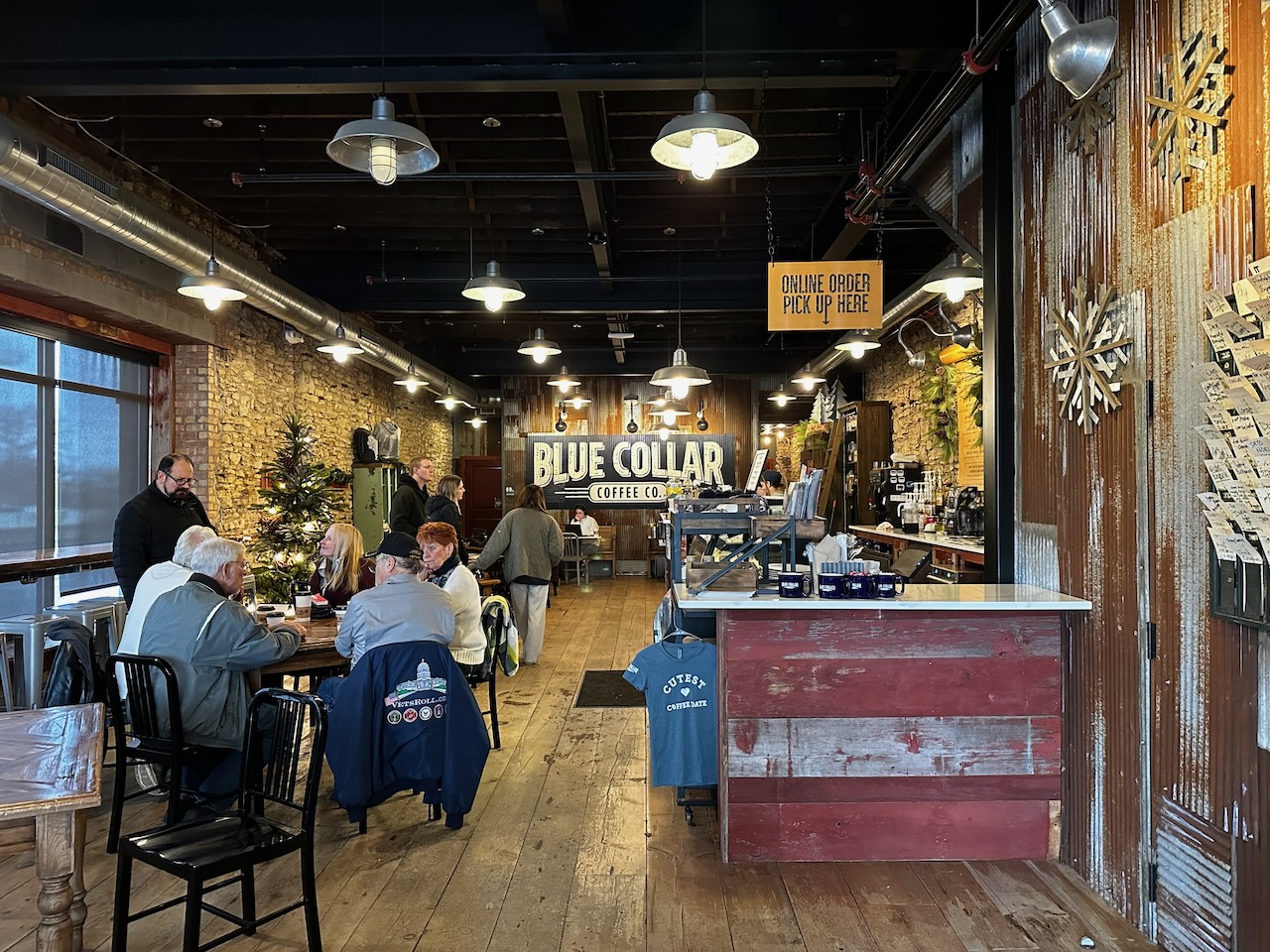 Interior of Blue Collar Coffee Co, with patrons at tables.