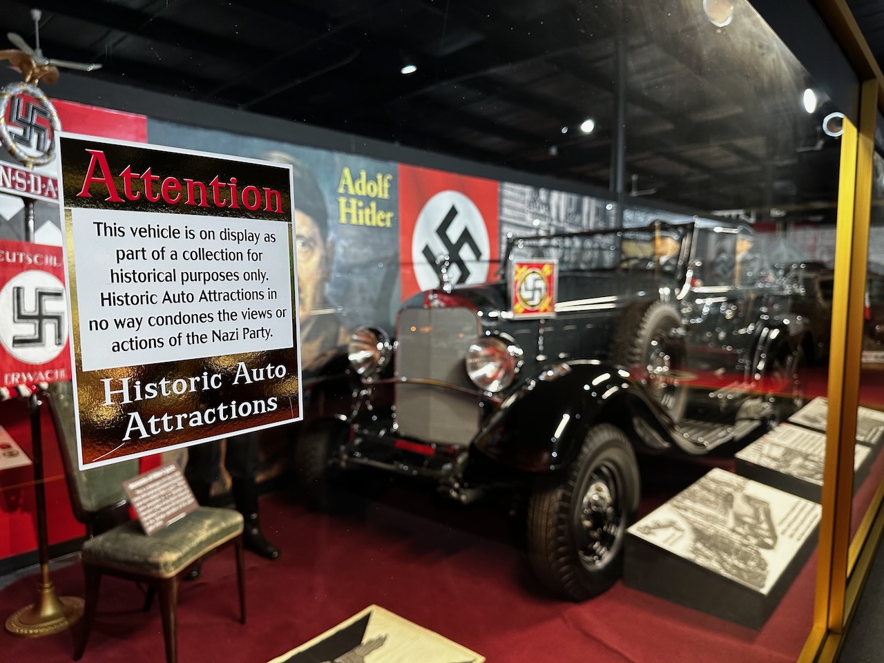 Display on Nazi German vehicles and artifacts, with sign indicating that the museum does not adhere to philosophy of Naziism and that objects are for educational purposes only.