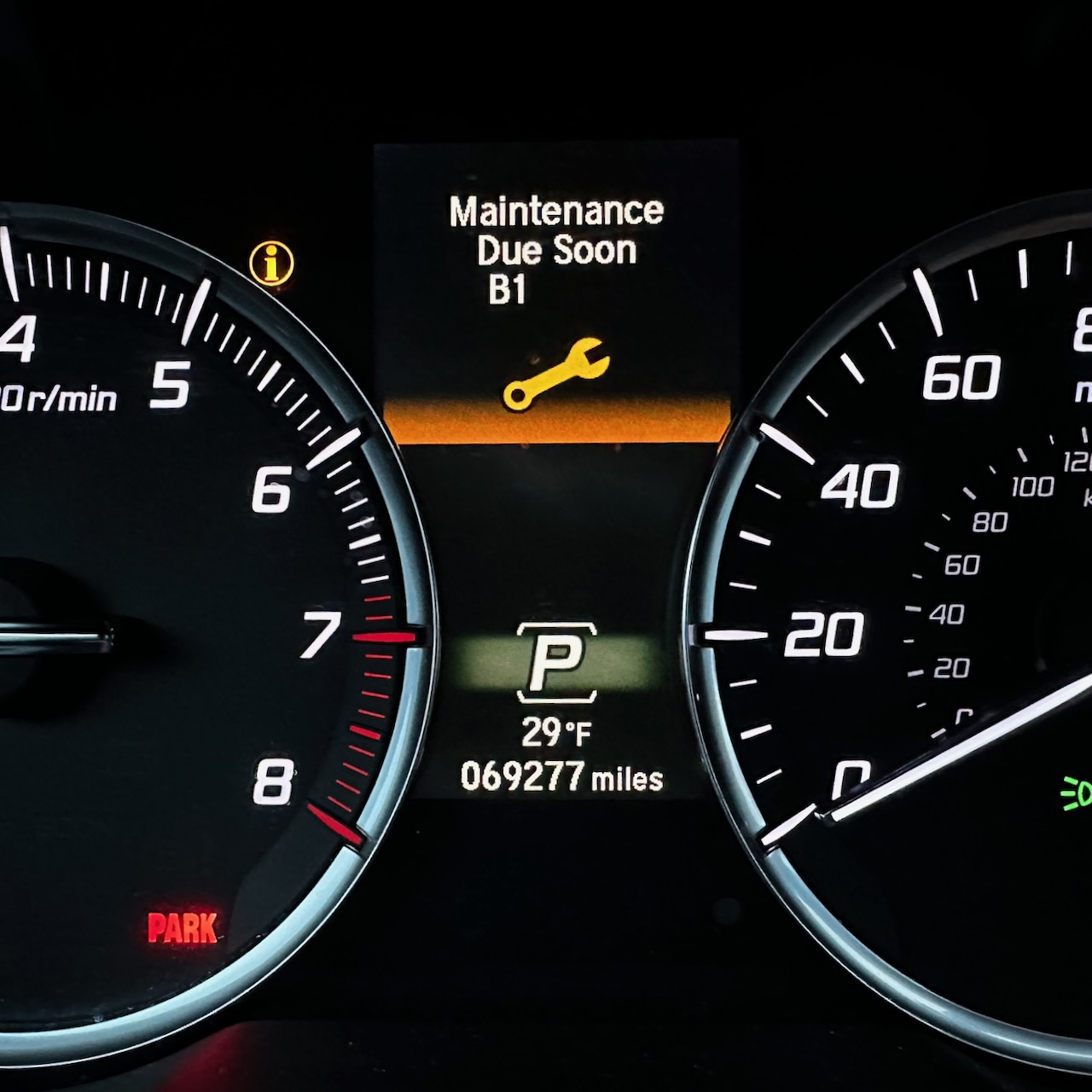 View of car instrument cluster with MAINTENANCE DUE SOON message on screen.