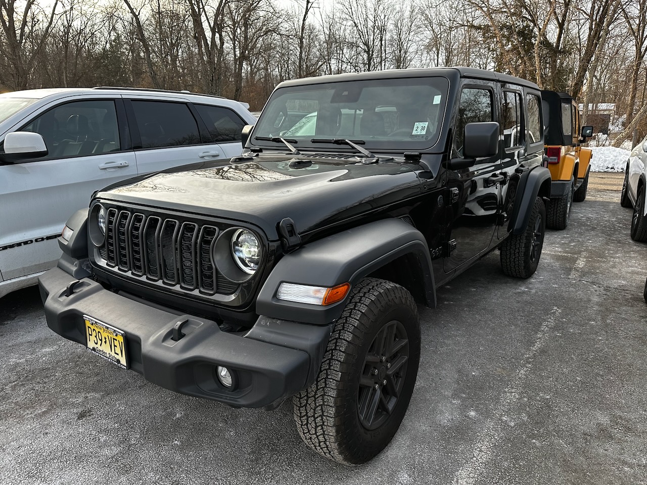 2025 Jeep Wrangler in black parked in dealer lot.