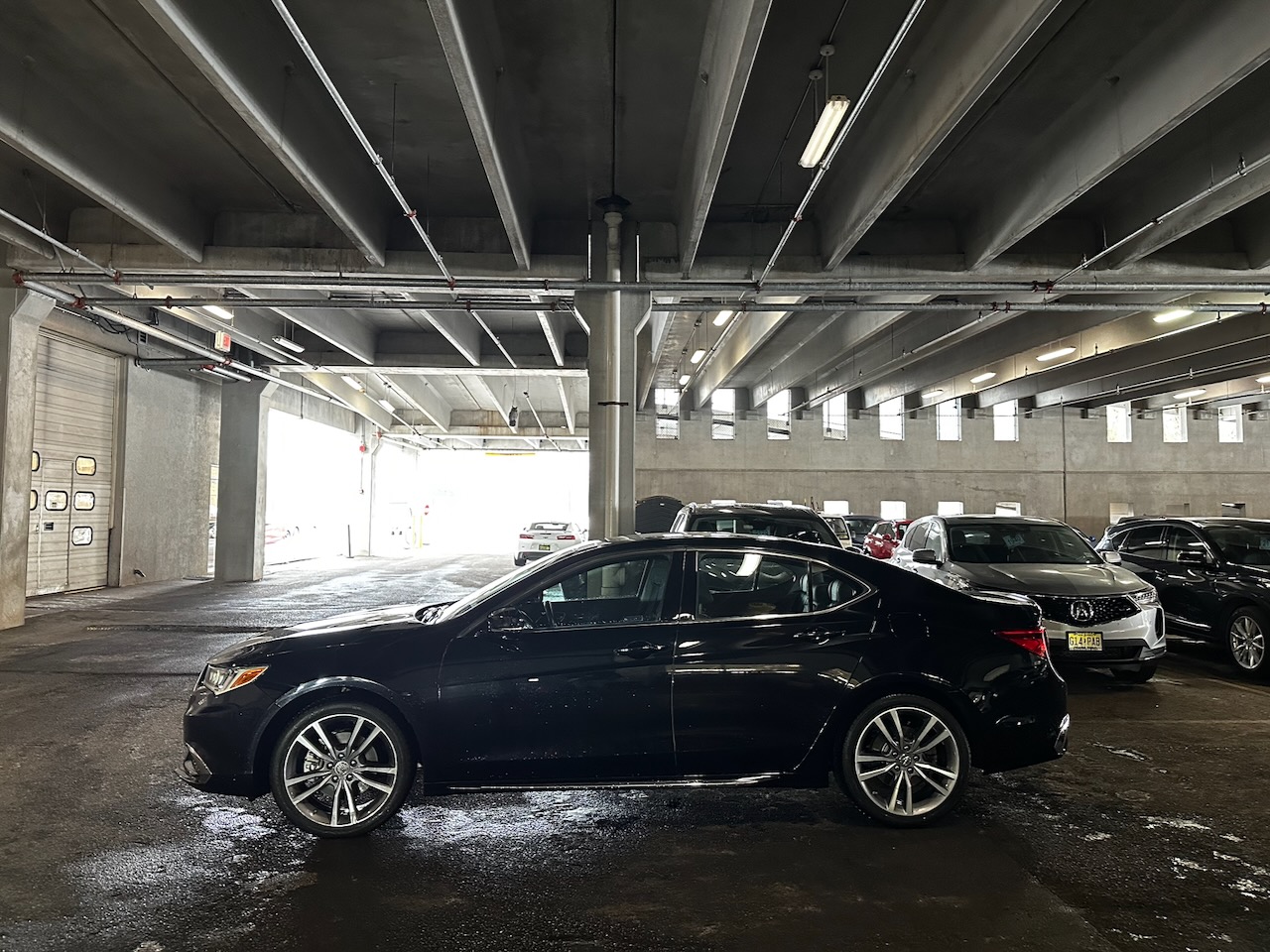 Black 2020 Acura TLX parked in garage at Acura dealership.
