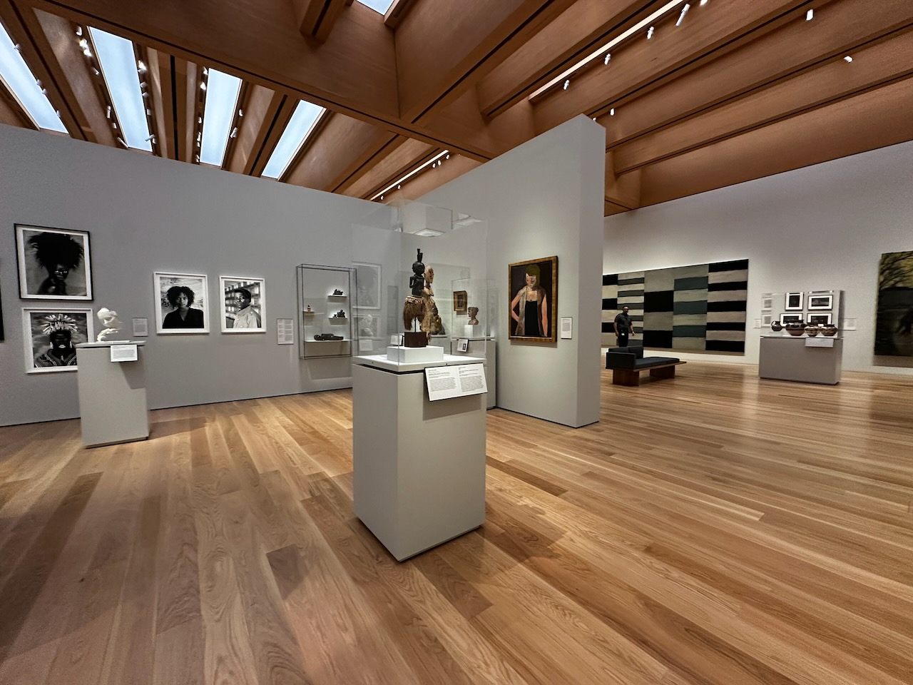 Museum gallery with sculptures and paintings.