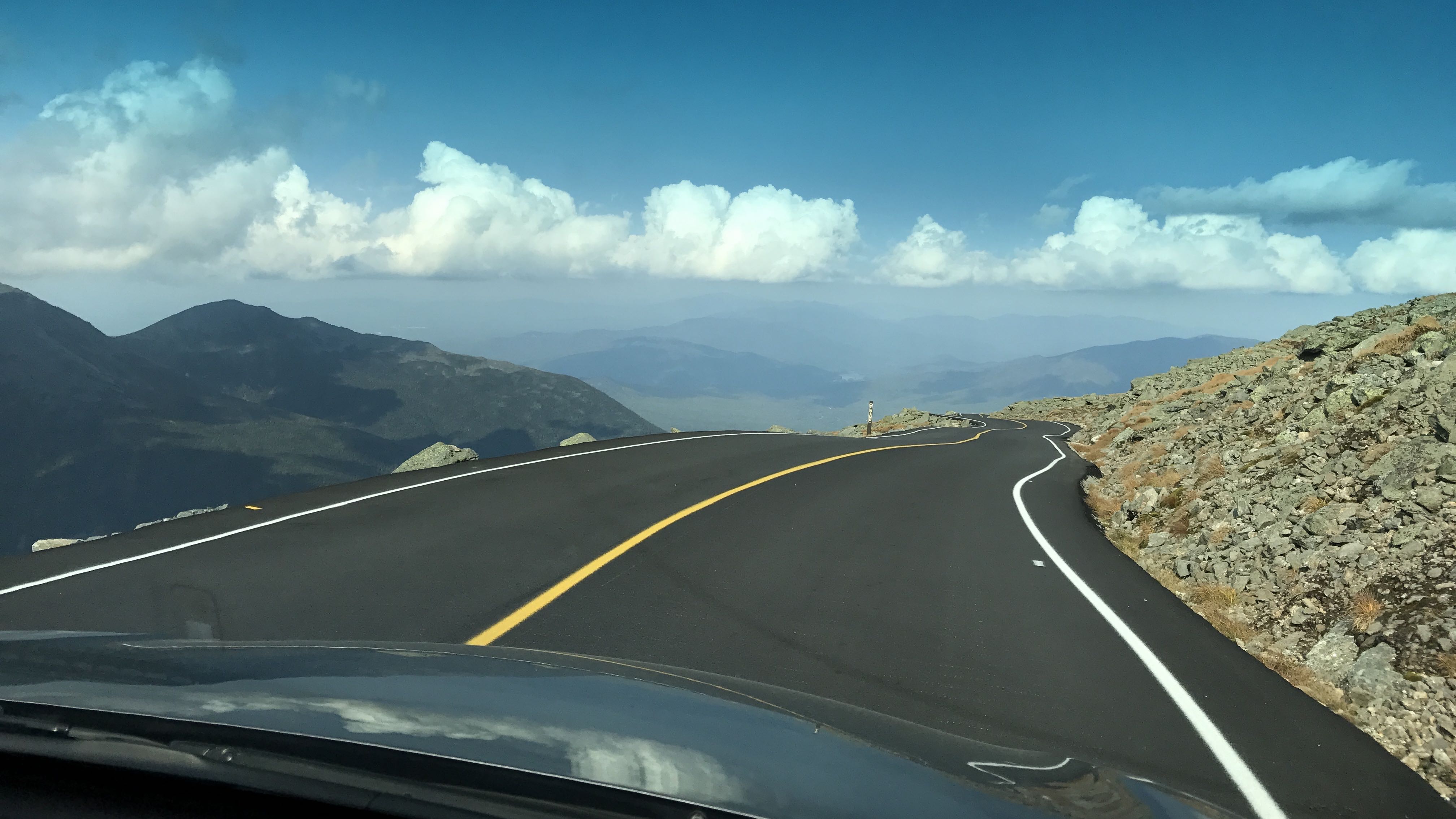 View of Mt. Washington Auto Road on a day with blue skies and light clouds.