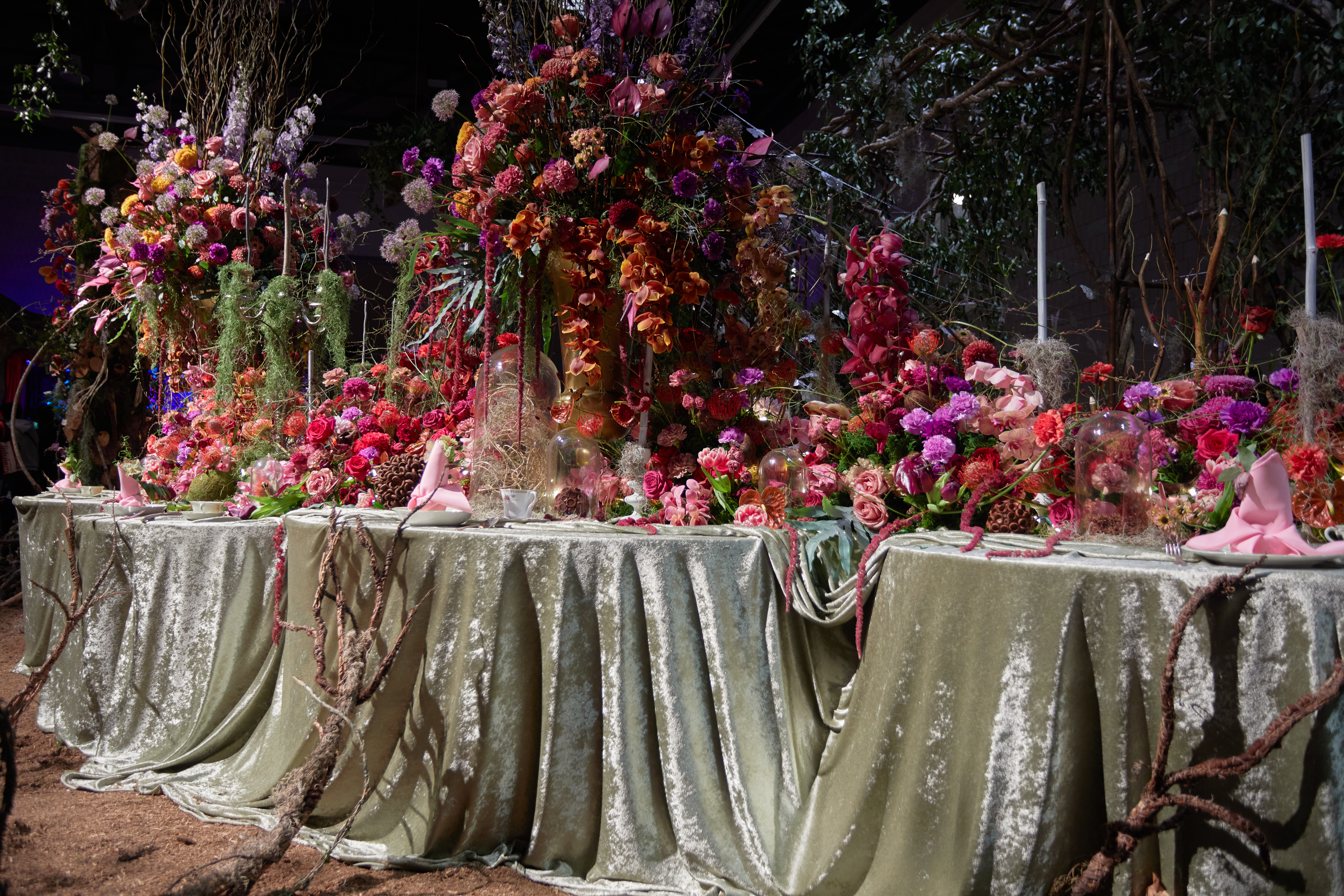 Tables with floral arrangements on top of them.