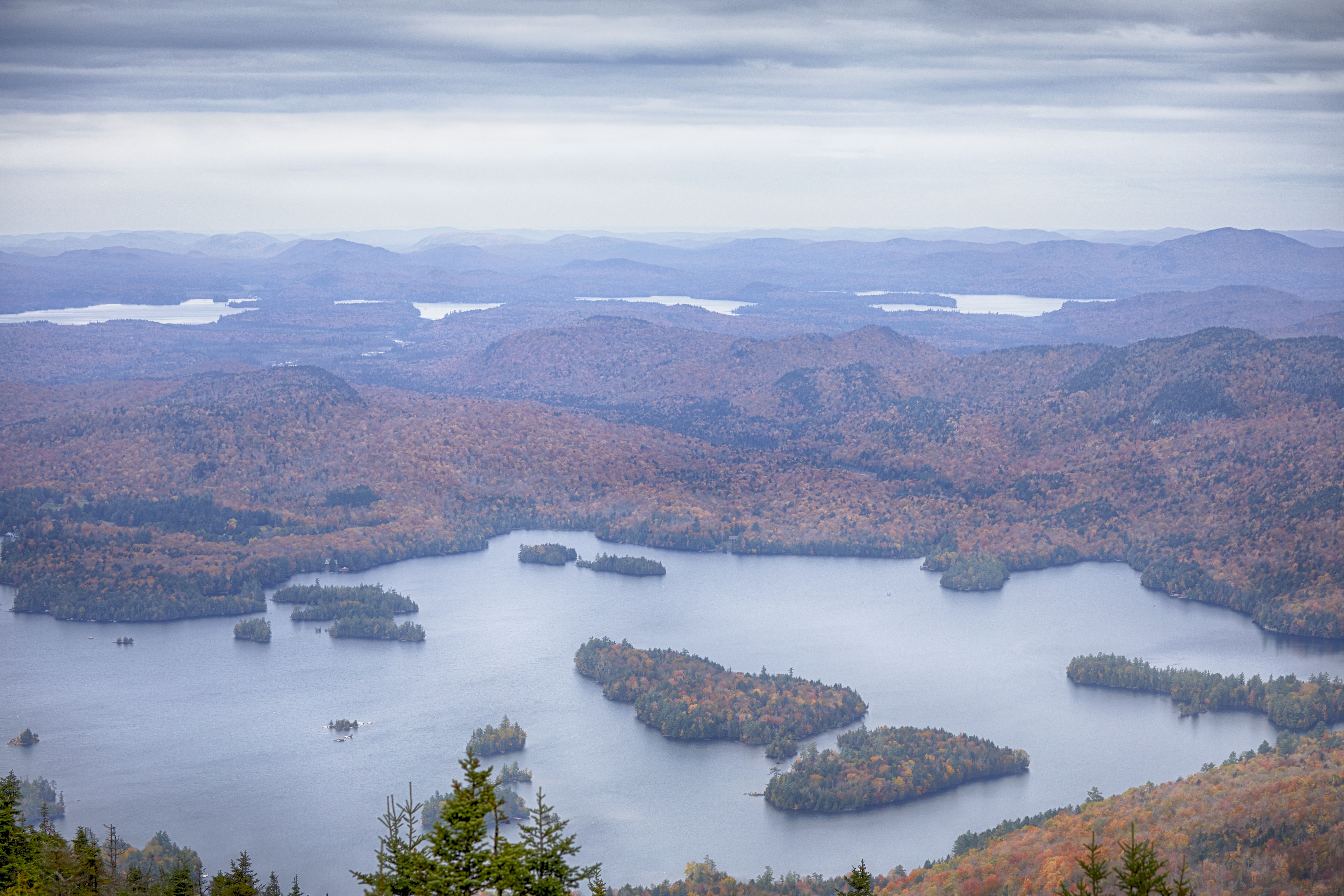 View of lake, forests, and mountains from summit of Blue Mountain.