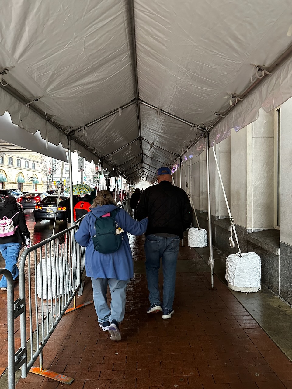 Entrance line to Philadelphia Flower Show. The line is beneath a temporary white tent.