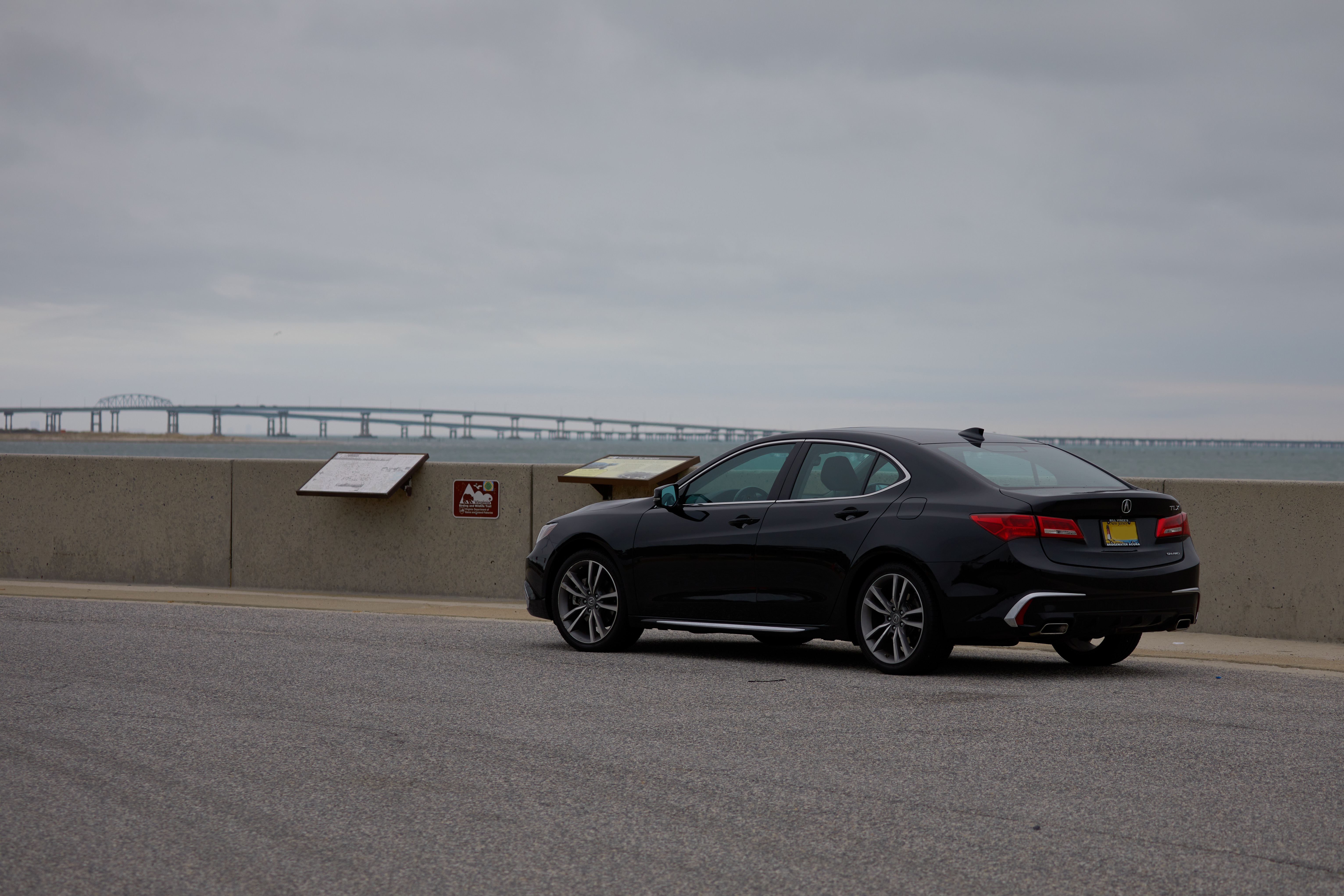 2020 Acura TLX parked on scenic turnout with Chesapeake Bay Bridge & Tunnel in background.