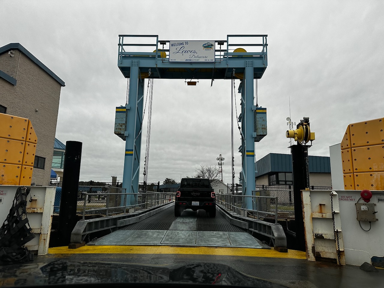 Exit ramp from ferry with WELCOME TO LEWES DELAWARE sign above ramp.