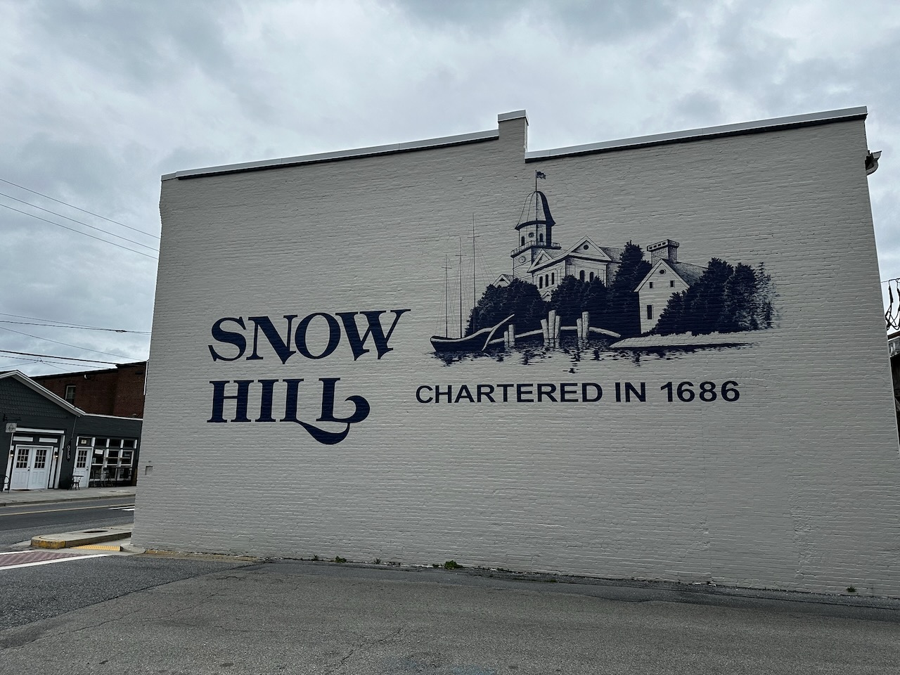 Mural on side of building for Snow Hill, with drawing of city line and words CHARTERED IN 1686.