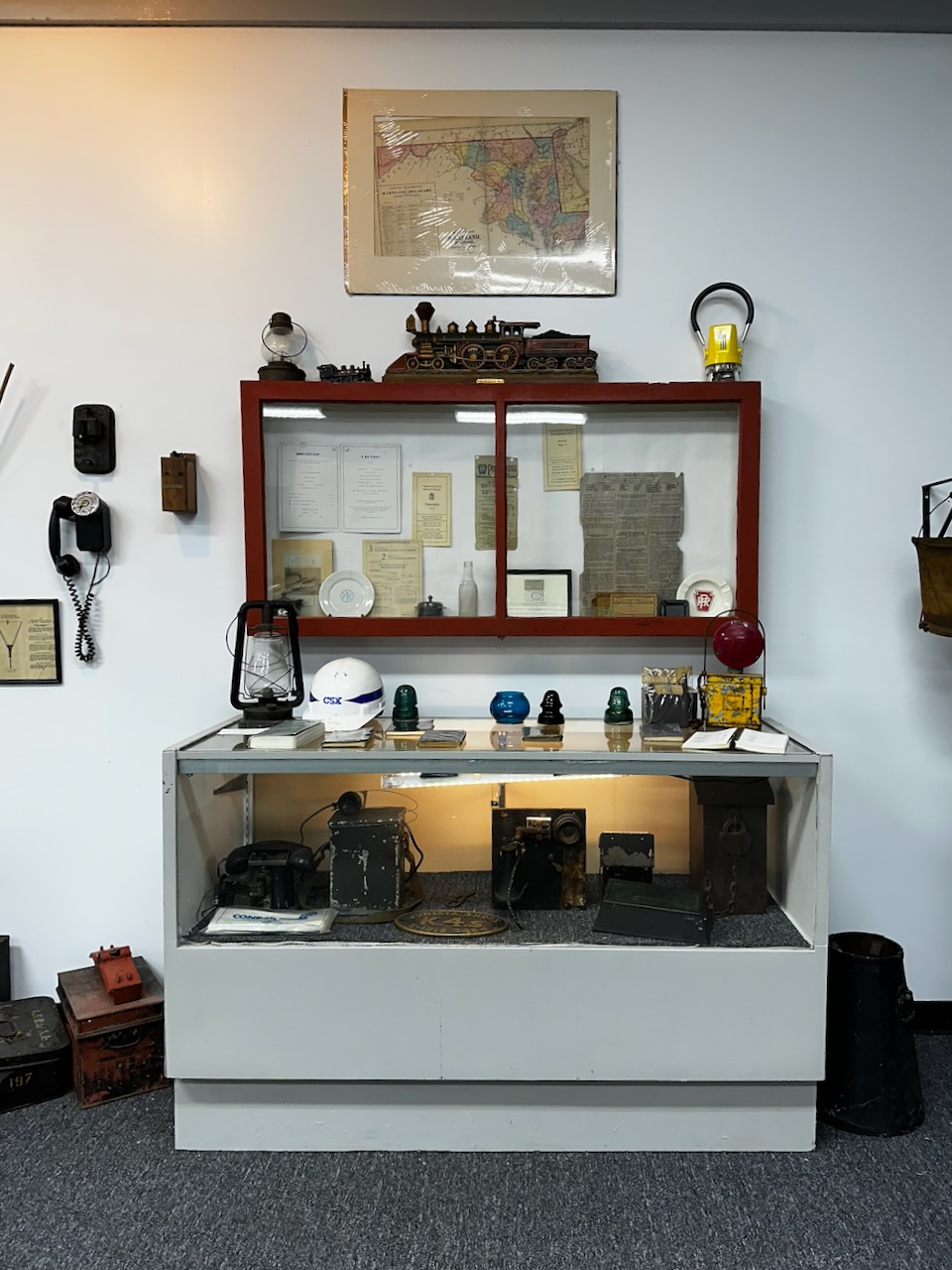 Small display of historic railroad equipment in museum.