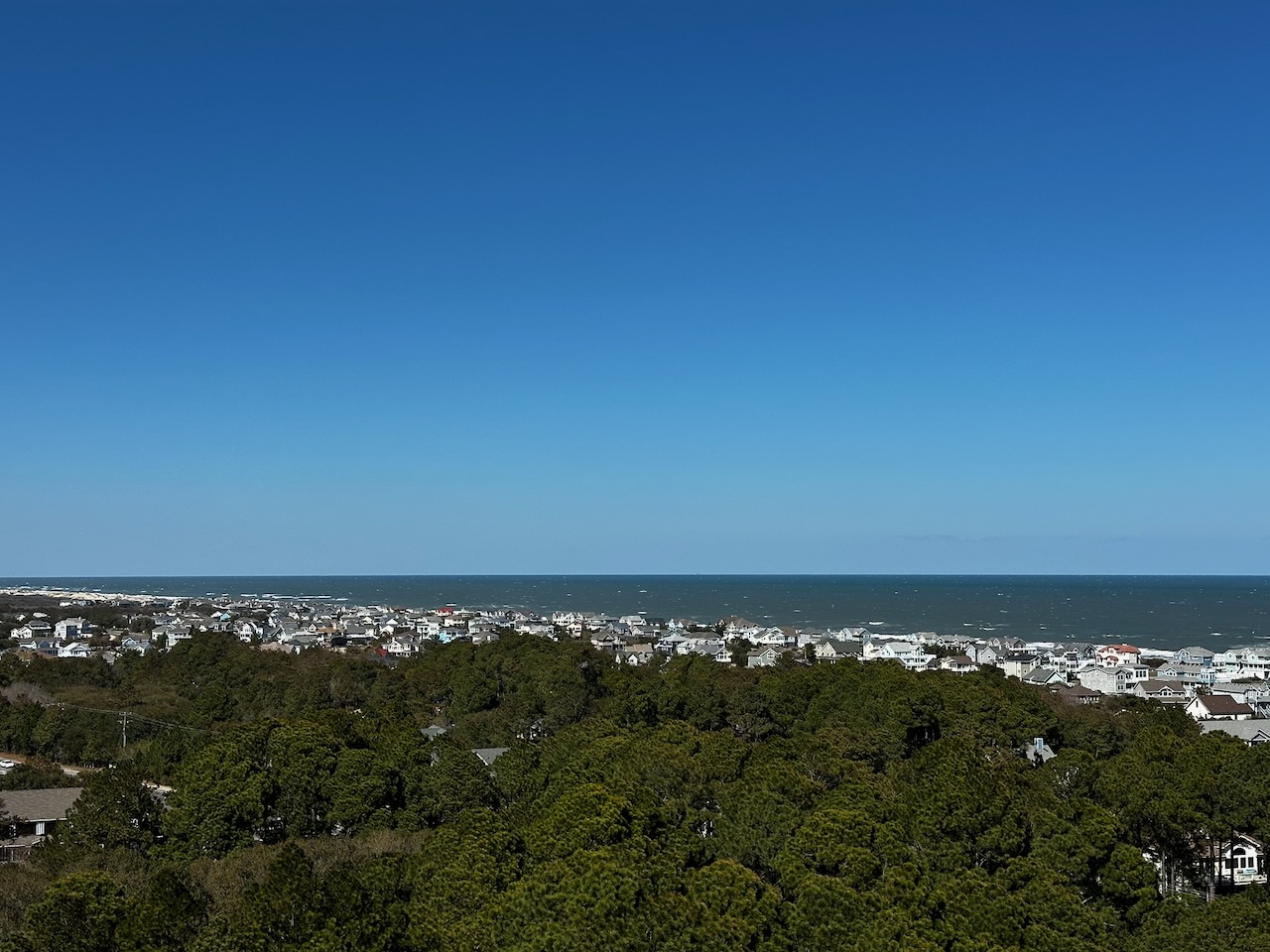 View of town of Corolla and surrounding woodlands.