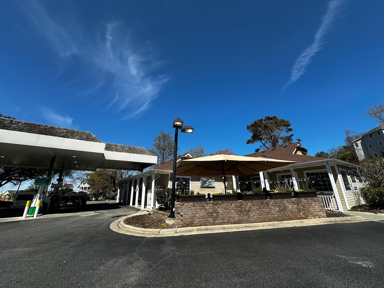 Exterior of Cravings Steaks and Seafood Restaurant, with gas station on left side of building.