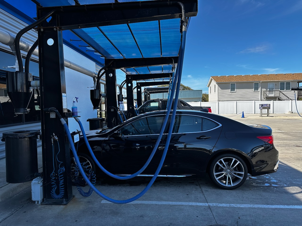 Acura TLX parked at vacuums of car wash.