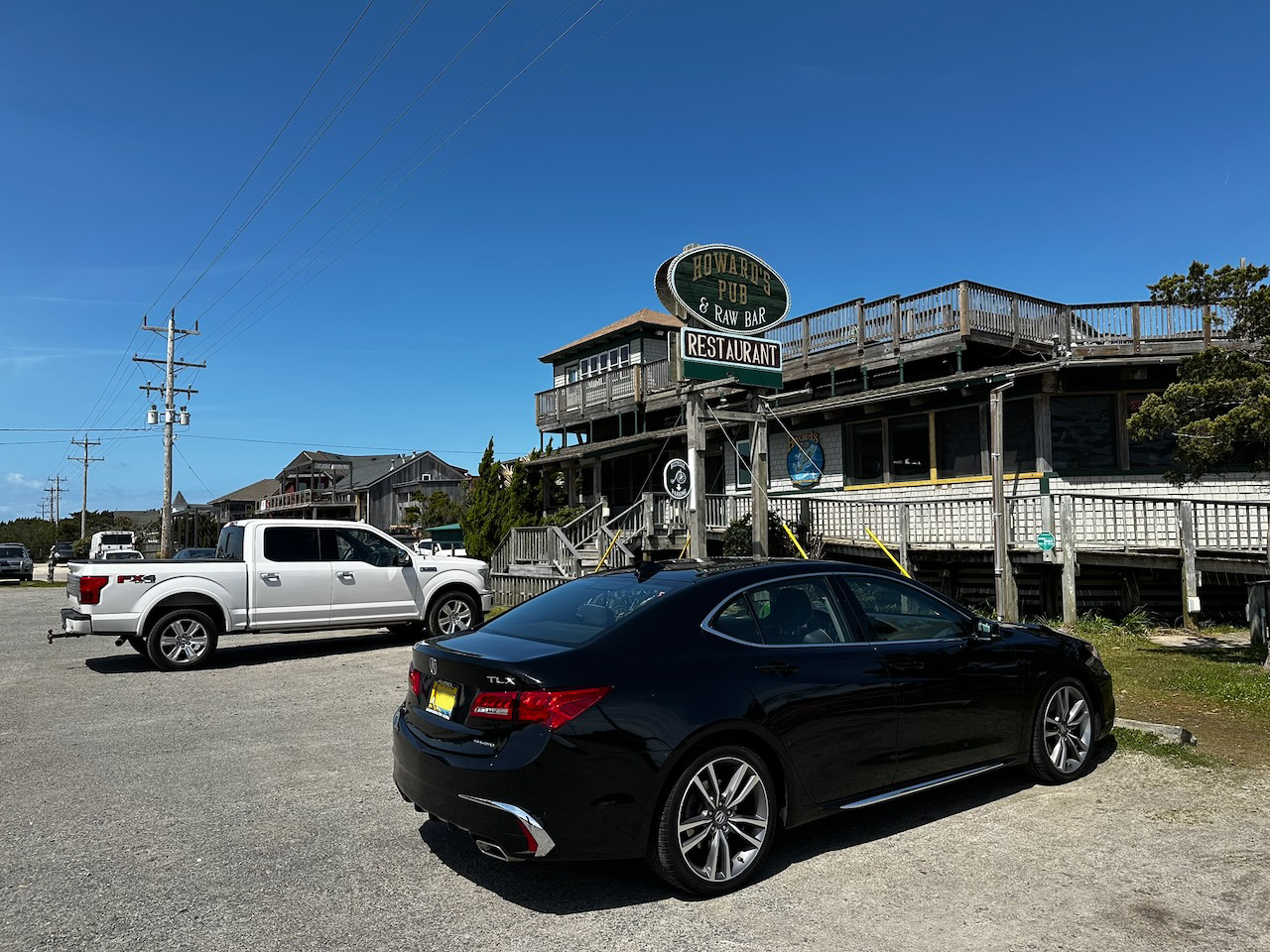2020 Acura TLX parked in front of Howard's Pub and Raw Bar.