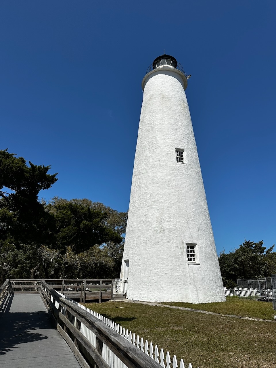 Ocracoke Island Lighthouse against a blue sky.