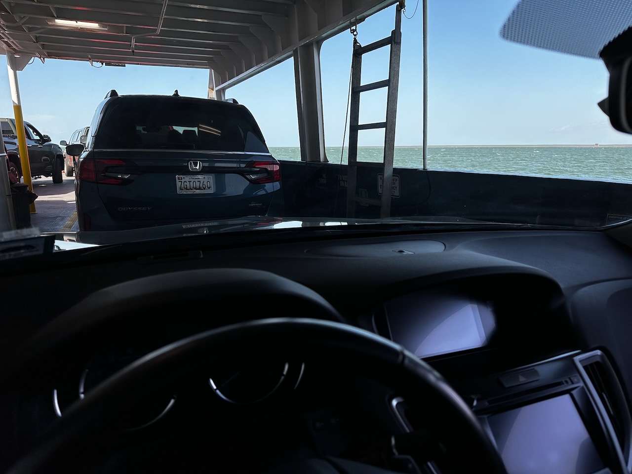 View of vehicle deck of ferry, with waters of Pamlico Sound in distance.