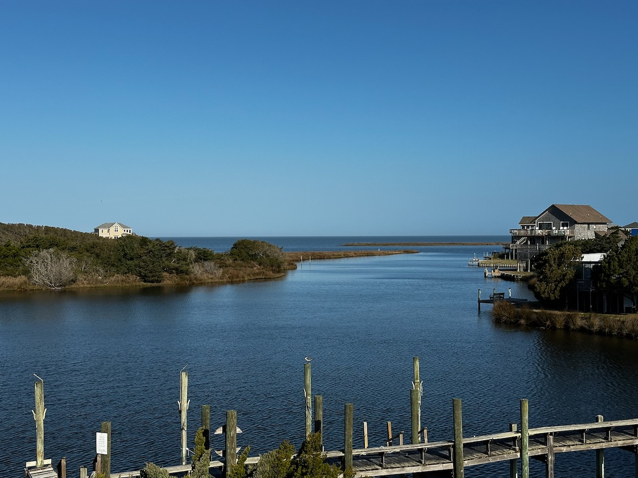 View of inlet and Pamlico Sound under a blue sky.