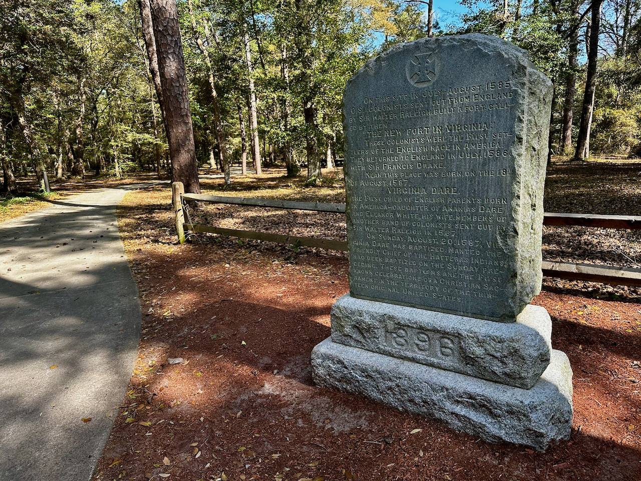 Stone marker beside hiking path.