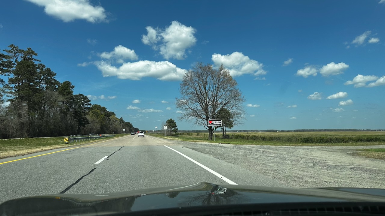 Welcome to Virginia sign beside four-lane country highway.
