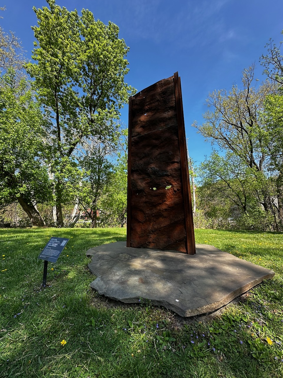 Upriver: Ripple Marks, Allentown Formation art work of sedimentary layers displayed above stone base.