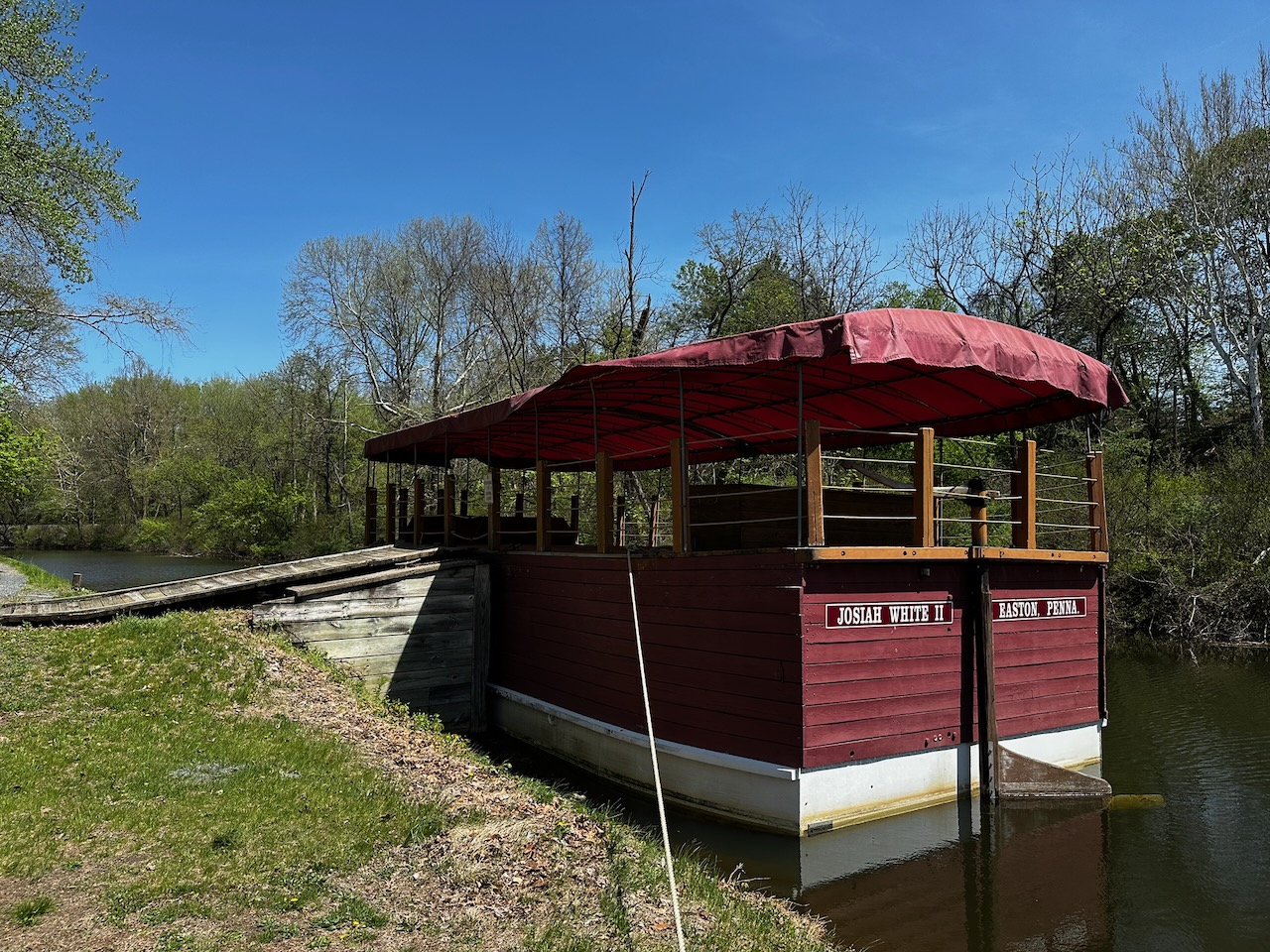 River boat tied to canal wall.