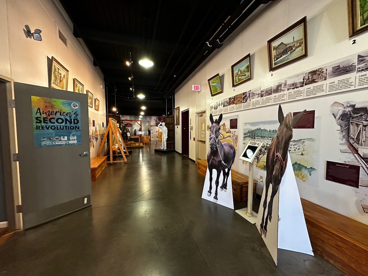 Entrance hall of museum, with exhibits on walls on both sides. 